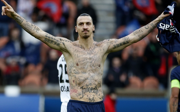 TOPSHOTS Paris Saint-Germain's Swedish forward Zlatan Ibrahimovic celebrates after scoring during the French L1 football match Paris Saint-Germain (PSG) vs Caen (SMC) at the Parc des Princes stadium in Paris on February 14, 2015. The match ended in a 2-2 draw. AFP PHOTO / KENZO TRIBOUILLARDKENZO TRIBOUILLARD/AFP/Getty Images